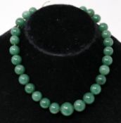 An antique, green hardstone, graduated bead necklace, L: 33cm, Largest bead: 2.3 x 1.3cm, 55g