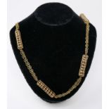 A 9ct yellow gold long chain necklace composed of seven pierced cylindrical panels to three strand