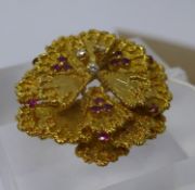 An 18ct yellow gold, flower-head brooch composed of eighteen gold petals studded with a total of