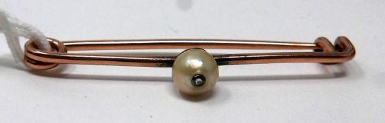 A Victorian, rose gold bar pin brooch centrally set with a natural pearl inset with a rose-cut