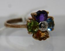 A 9ct yellow gold clover ring set with amethyst, peridot, citrine and blue topaz to a dimaond