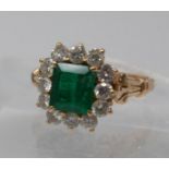 A Boxed, 18ct yellow gold diamond and emerald cluster ring, the central, stepped-cut emerald (6 x