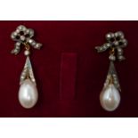A boxed pair of antique yellow gold earrings set with diamond-studded bows to a pearl drop, 3.5 x
