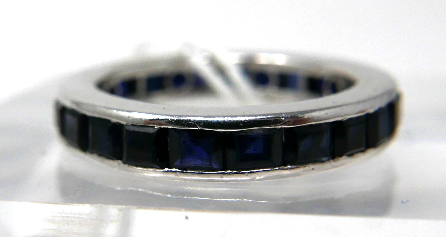 An 18ct white gold and callibre-cut sapphire ring composed of 24 natural sapphires in a channel-