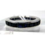An 18ct white gold and callibre-cut sapphire ring composed of 24 natural sapphires in a channel-