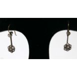 A pair of antique, yellow gold, rose-cut diamond drop earrings composed of a single diamond