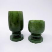 Two nephrite green jade liqueur cups having hand-carved faceted bases and stems, H: 7.5cm Dia: 3.5cm