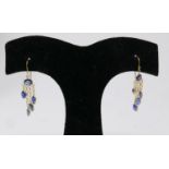 A pair of 14ct yellow gold, natural sapphire drop earrings, each earring set with five, oval,