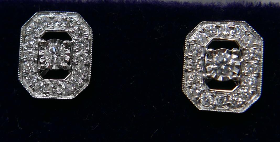 A pair of 18ct white gold and diamond stud earrings (0.50 carats), each earring set with a central