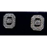 A pair of 18ct white gold and diamond stud earrings (0.50 carats), each earring set with a central