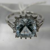 A 9ct white gold, diamond and aquamarine cluster ring, centrally set with a square, princess cut