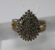 A 9ct yellow and white gold diamond studded ring set with brilliant and baguette-cut diamonds to