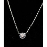 A boxed, 18ct white gold and diamond circular dics pendant (0.14 carats) on an 9ct white gold chain,