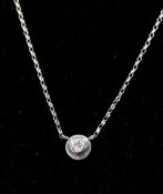 A boxed, 18ct white gold and diamond circular dics pendant (0.14 carats) on an 9ct white gold chain,