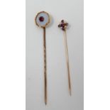 Two, Victorian, yellow gold stick pins: circular white agate and ruby example L: 6.5cm and