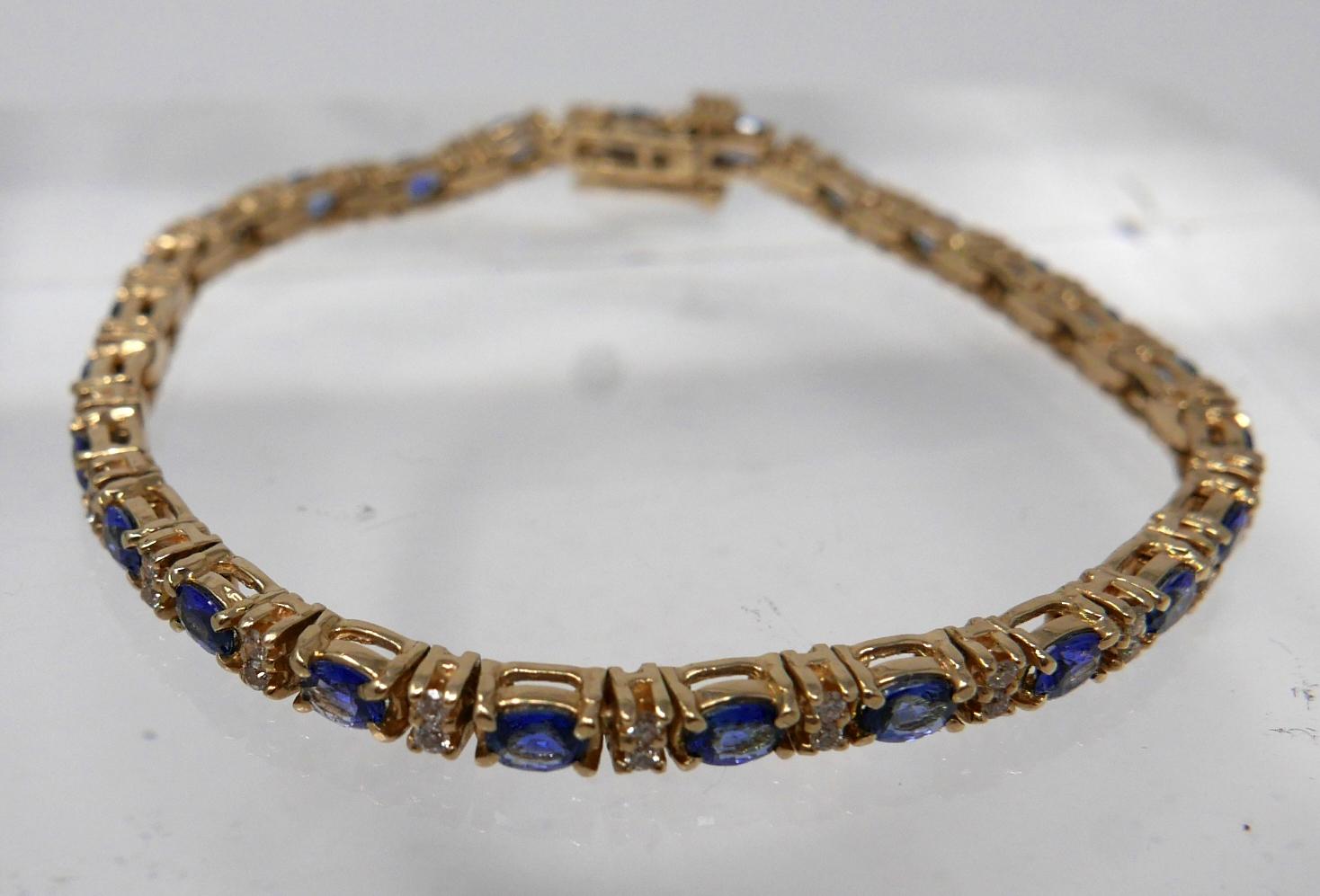 A 14ct yellow gold diamond and tanzanite tennis bracelet set with alternating stones of 50 - Image 2 of 4