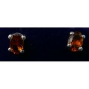 A boxed pair of sterling silver and oval orange tourmaline stud earrings, 5 x 4mm, 1.2g.