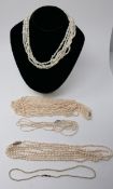 Five pearl strand necklaces, L: 34cm, 42cm, 40cm, 44cm and long five-strand example L: 85cm