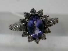 A 9ct white gold, tanzanite and white sapphire cluster ring, Size: J 1/2, 2.5g.