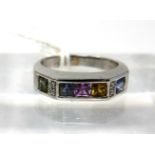 An 18ct white gold, multi sapphire and diamond ring, channel set with 5 square, princess cut