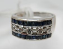 A large, 18ct white gold Art Deco style diamond and sapphire ring, set centrally with five, round,