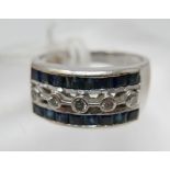 A large, 18ct white gold Art Deco style diamond and sapphire ring, set centrally with five, round,