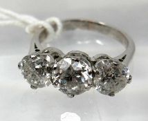 An 18ct white gold, 3-stone brilliant-cut diamond ring, (3.22 carats total), Size: L, 4.6g.