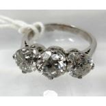 An 18ct white gold, 3-stone brilliant-cut diamond ring, (3.22 carats total), Size: L, 4.6g.