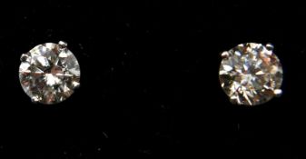 A pair of 14ct white gold, brilliant-cut diamond solitaire stud earrings (0.86 carats), 1g.