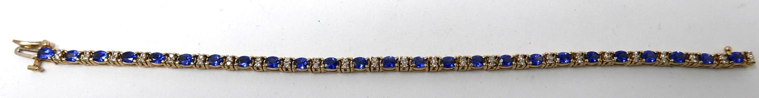 A 14ct yellow gold diamond and tanzanite tennis bracelet set with alternating stones of 50