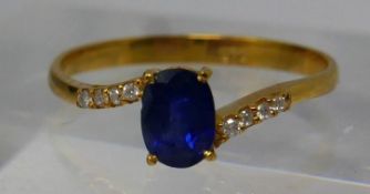 A 14ct yellow gold, diamond and Ceylon sapphire ring, centrally set with a round, natural, faceted