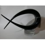 A Murano, Italian, black and clear glass abstract form sculpture on a clear glass circular base,