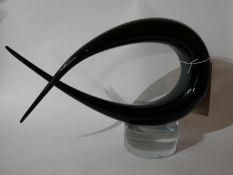 A Murano, Italian, black and clear glass abstract form sculpture on a clear glass circular base,