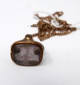 A Georgian pinchbeck fob pendant set with a hand-carved amethyst panel depicting a racing hound