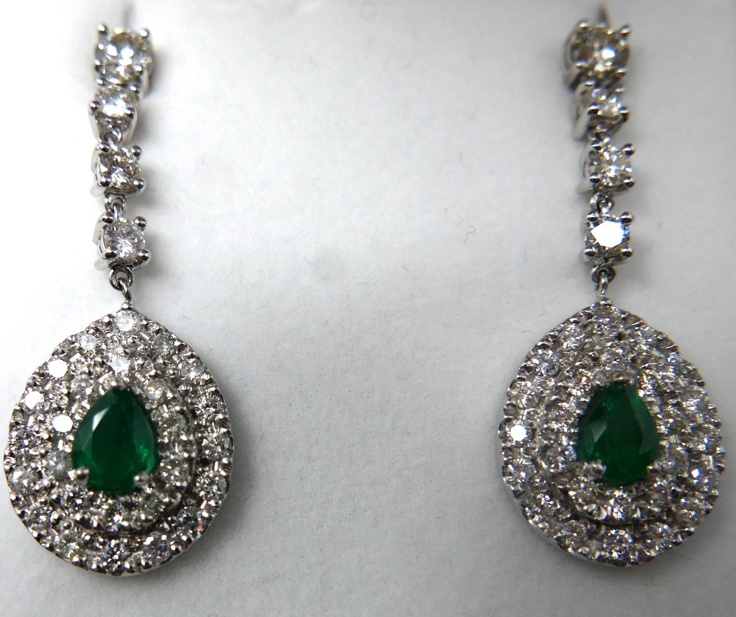 A boxed pair of 18ct white gold emerald and diamond cluster drop earrings, each earring suspended by - Image 2 of 2