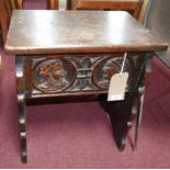 A late 19th century Continental carved oak box stool with hinged lift up lid. H.53 W.46 D.30cm