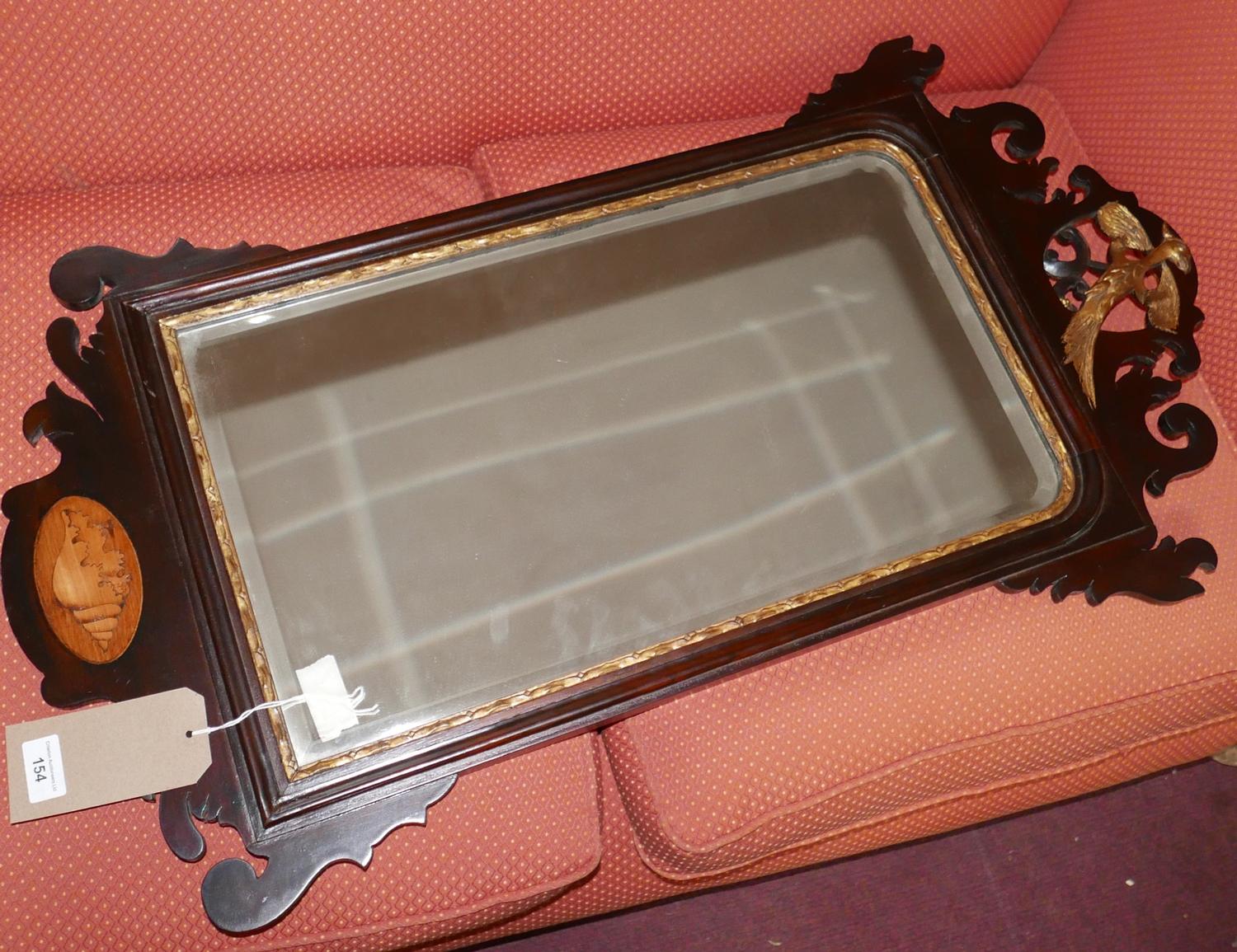 A Georgian mahogany fretwork mirror, with shell paterae and Phoenix decoration, having bevelled