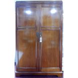 An early 20th century mahogany wardrobe, two doors enclosing hanging space, labelled drawers, some