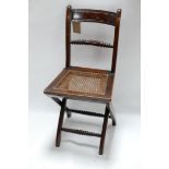 A Georgian mahogany folding campaign chair with cane seat