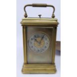 An early 20th century brass carriage clock, with bevelled glass plates, the dial signed T.Elliot and