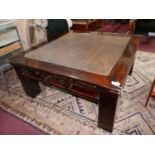 A Chinese hardwood low table, with rattan top, raised on square legs, H.54 W.100 D.100cm