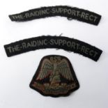 A WWII Raiding Support Regiment cloth cap badge, together with two cloth badges for The Raiding