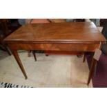 A 19th century mahogany fold over tea table, raised on tapered legs and castors, H.74 W.102 D.51cm