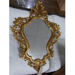 A Rococo style gilt framed carved wood floral wall mirror. H.102 W.75cm