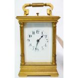 A 20th century brass repeating carriage clock, with white enameled dial and Arabic numerals, chiming