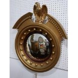 A Regency style gilt convex wall mirror with eagle surmount, H.67 W.57cm