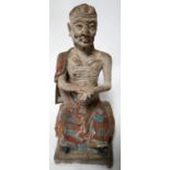 A Chinese early Ming Dynasty stucco figure of Lohan, polychrome painted, with paperwork from