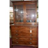 A Regency mahogany secretaire bookcase, two glazed doors enclosing adjustable shelves, the pull