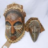 An African tribal Bongo helmet mask, Kuba people, DRC, carved and painted wood with feathers and