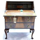 A walnut bureau, with compartmentalised interior having plaque 'presented to JTW Peat 1936' above